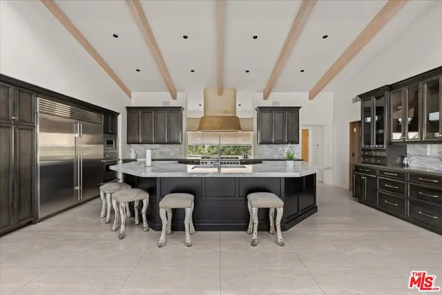 a large kitchen with a table and chairs in it