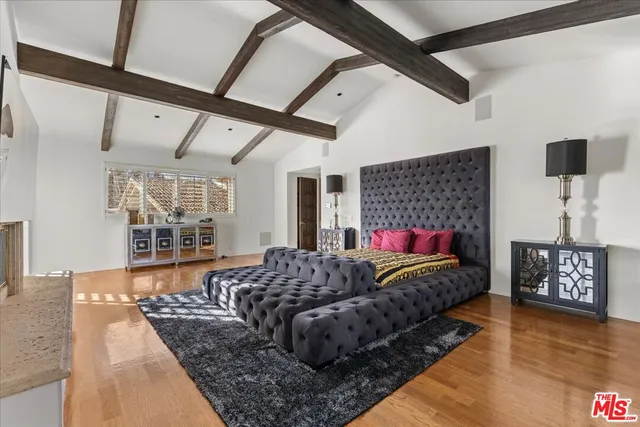 a living room with a bed furniture and next to a window