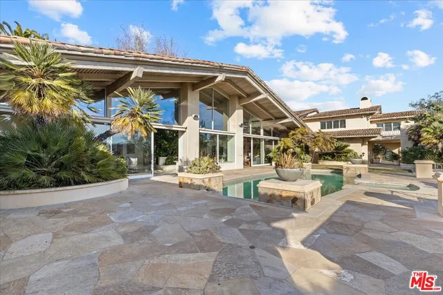 a view of a patio with dining table and chairs with wooden floor