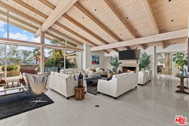a living room with furniture and a floor to ceiling window