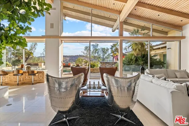 a view of an outdoor dining space with a table and chairs