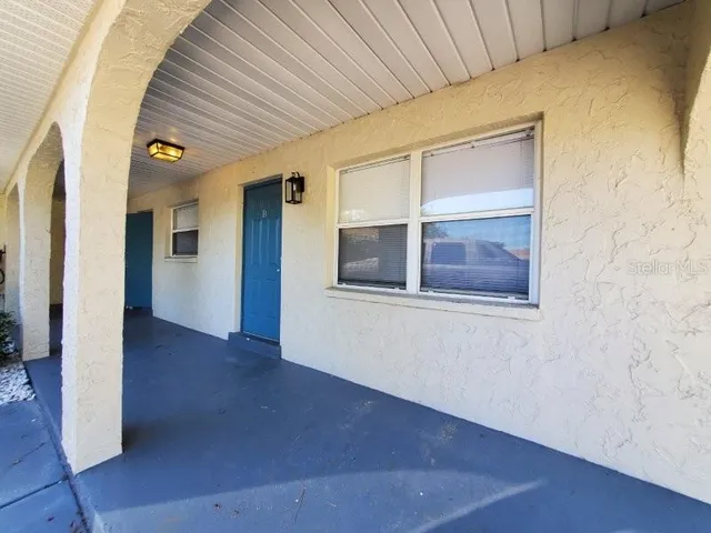 a view of a balcony with two chairs and a table