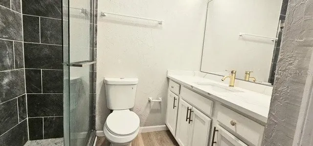 a bathroom with a sink toilet and a mirror