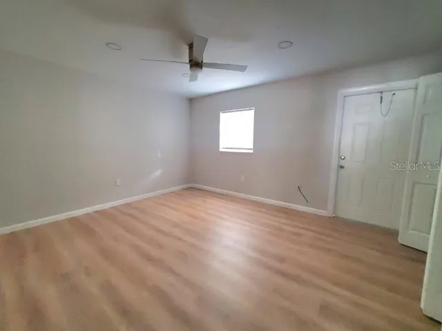 wooden floor in an empty room with a window