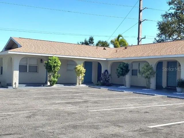 a front view of a house with garden and plants