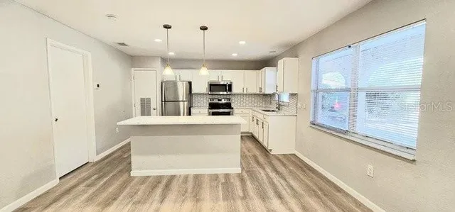 a view of kitchen with wooden floor