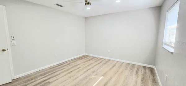 a view of room with window and hardwood floor