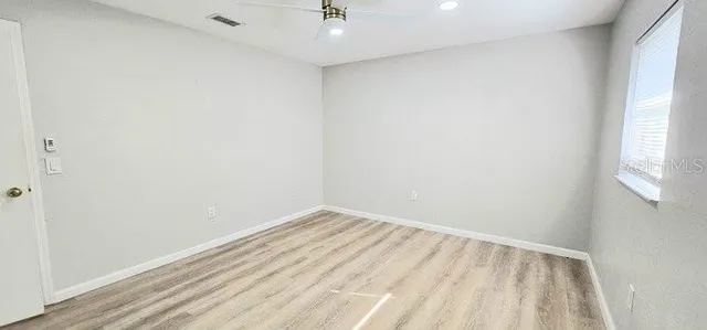 a view of room with window and hardwood floor
