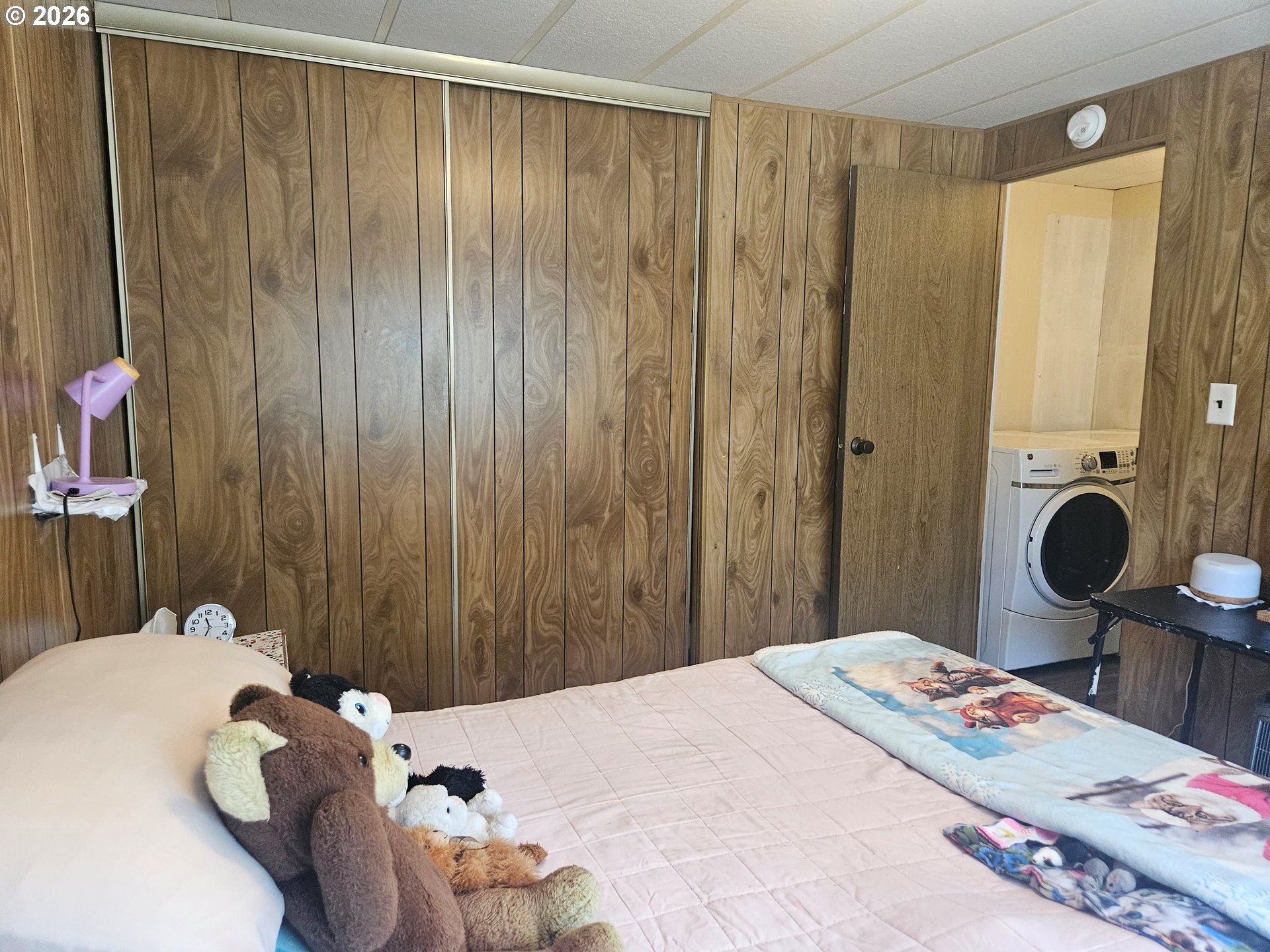 1600 Rhododendron Drive, Unit 214 Florence, OR 97439 - Photo 19 of 38 a bedroom with a bed and a chandelier