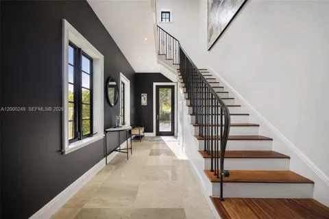 a view of an entryway with wooden floor and door