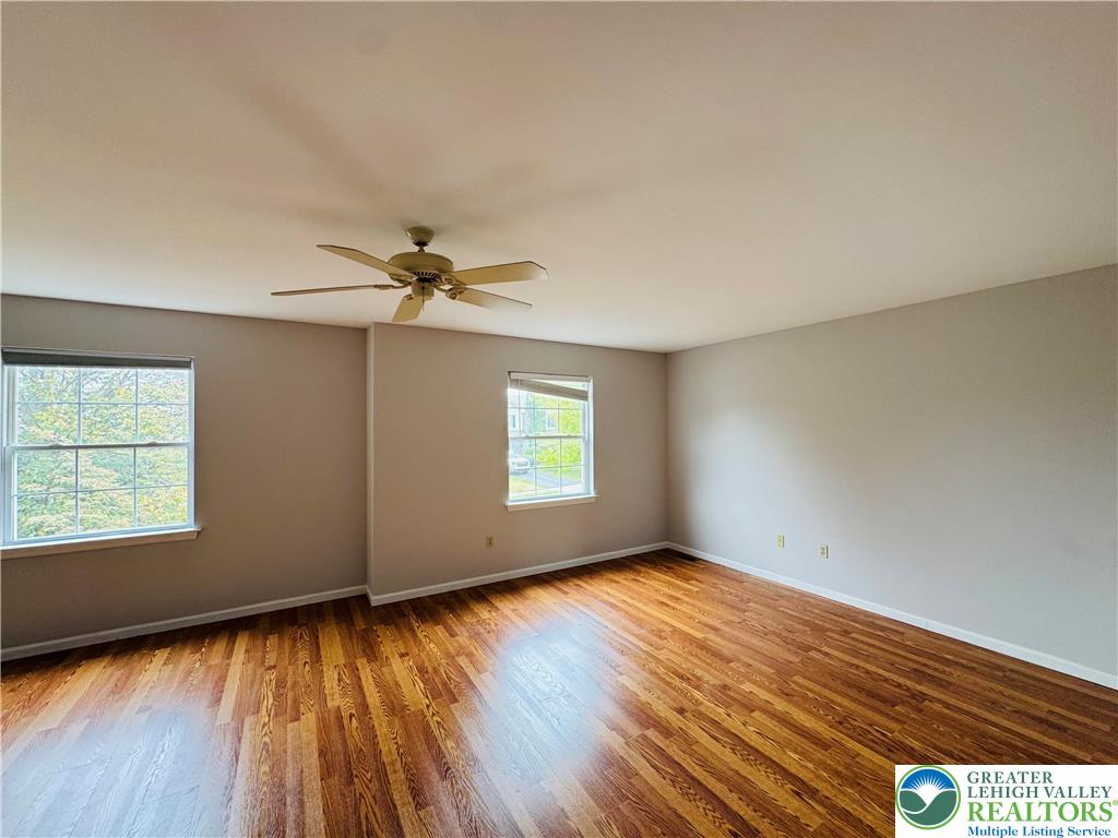 4034 Reeve Drive Bethlehem, PA 18020 - Photo 17 of 36 an empty room with wooden floor windows and fan