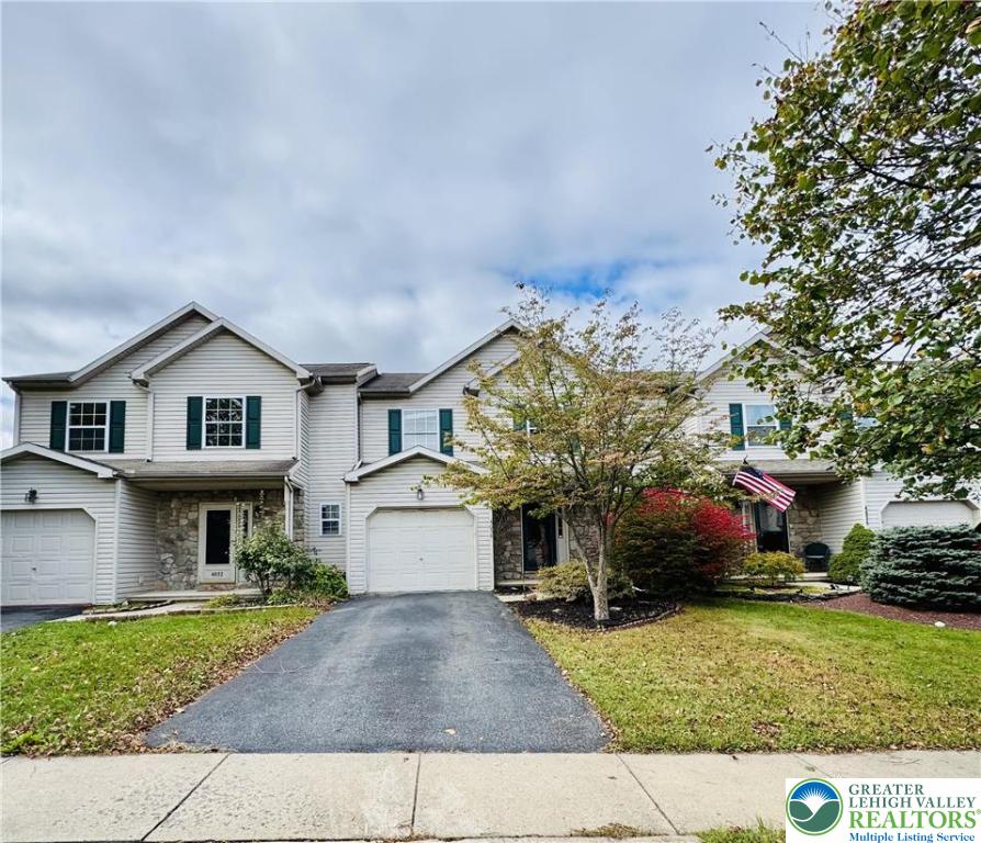 4034 Reeve Drive Bethlehem, PA 18020 - Photo 2 of 36 a front view of a house with a yard and garage