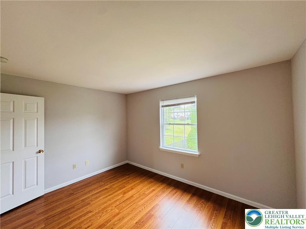 4034 Reeve Drive Bethlehem, PA 18020 - Photo 23 of 36 a view of an empty room with wooden floor and a window