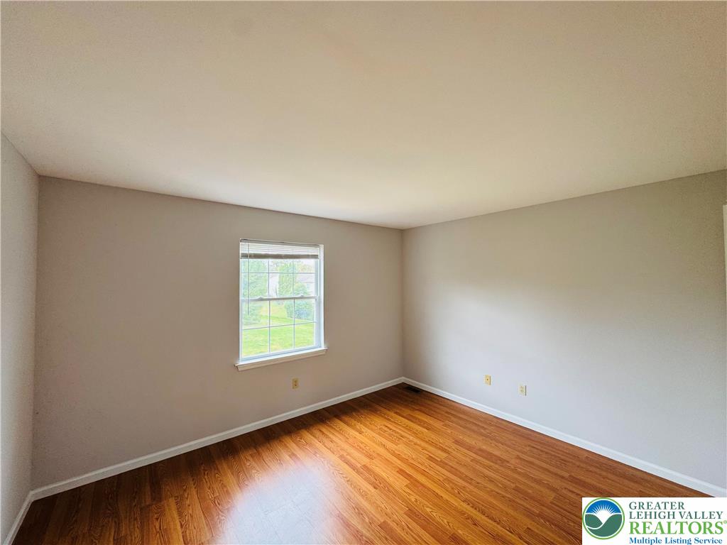 4034 Reeve Drive Bethlehem, PA 18020 - Photo 24 of 36 an empty room with wooden floor and windows