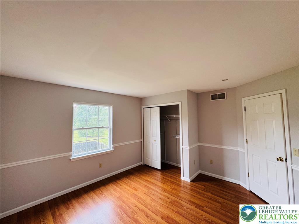 4034 Reeve Drive Bethlehem, PA 18020 - Photo 25 of 36 an empty room with wooden floor and windows