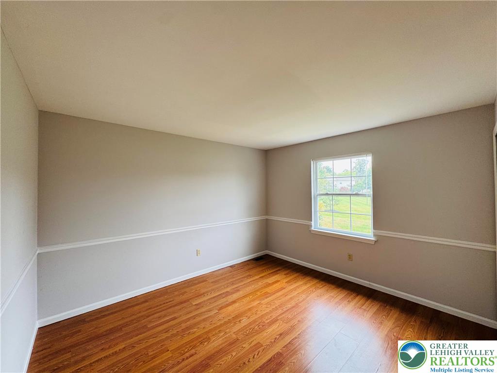 4034 Reeve Drive Bethlehem, PA 18020 - Photo 26 of 36 an empty room with wooden floor and windows