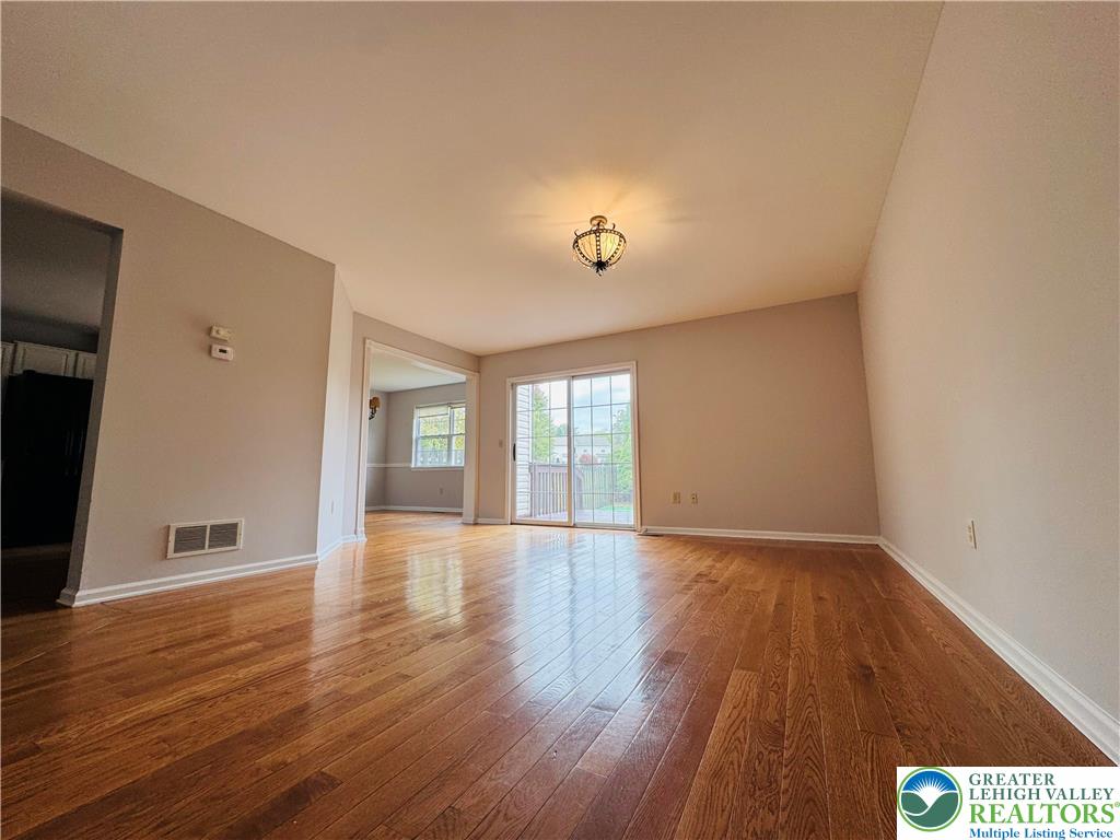 4034 Reeve Drive Bethlehem, PA 18020 - Photo 4 of 36 a view of an empty room with wooden floor and a window