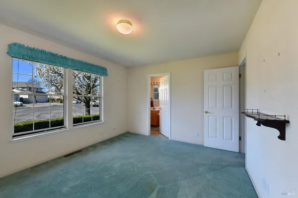 a view of an empty room and closet area