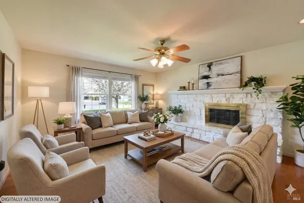 a living room with furniture fireplace and window