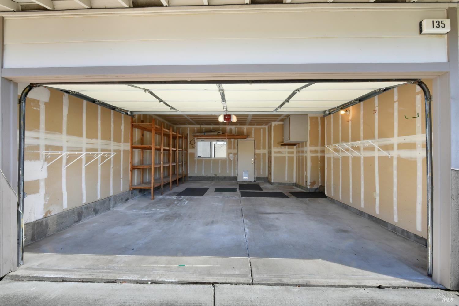 135 Fulton Place Windsor, CA 95492 - Photo 37 of 42 Spacious garage offers abundant storage, a door to the back yard, and a passage to the the utility room and the hall to the suite addition, and the kitchen