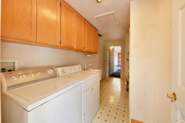 a view of a room with door wooden floor and windows