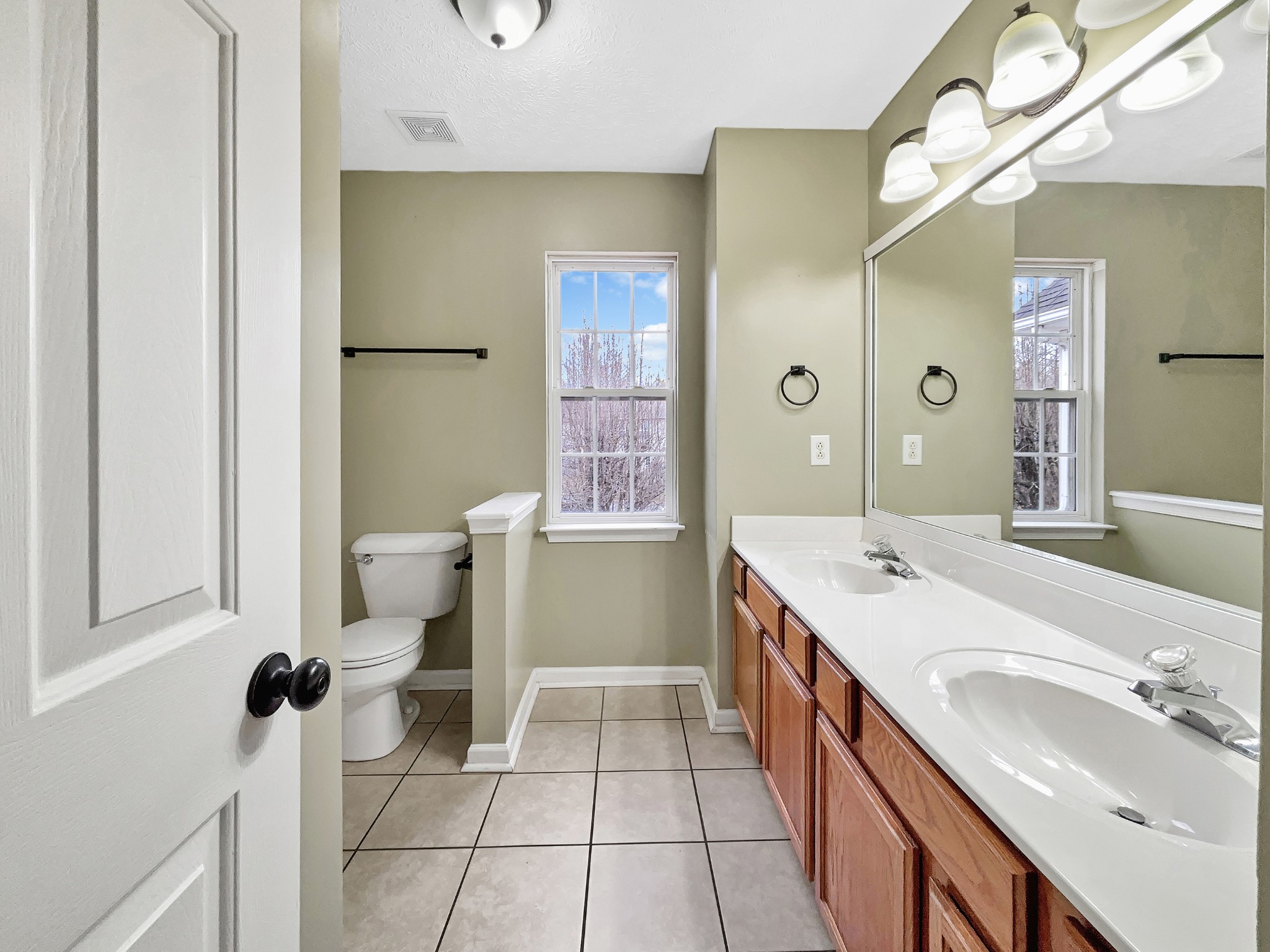 741 Tulip Grove Road, Unit 603 Hermitage, TN 37076 - Photo 12 of 17 a spacious bathroom with a double vanity sink mirror and toilet
