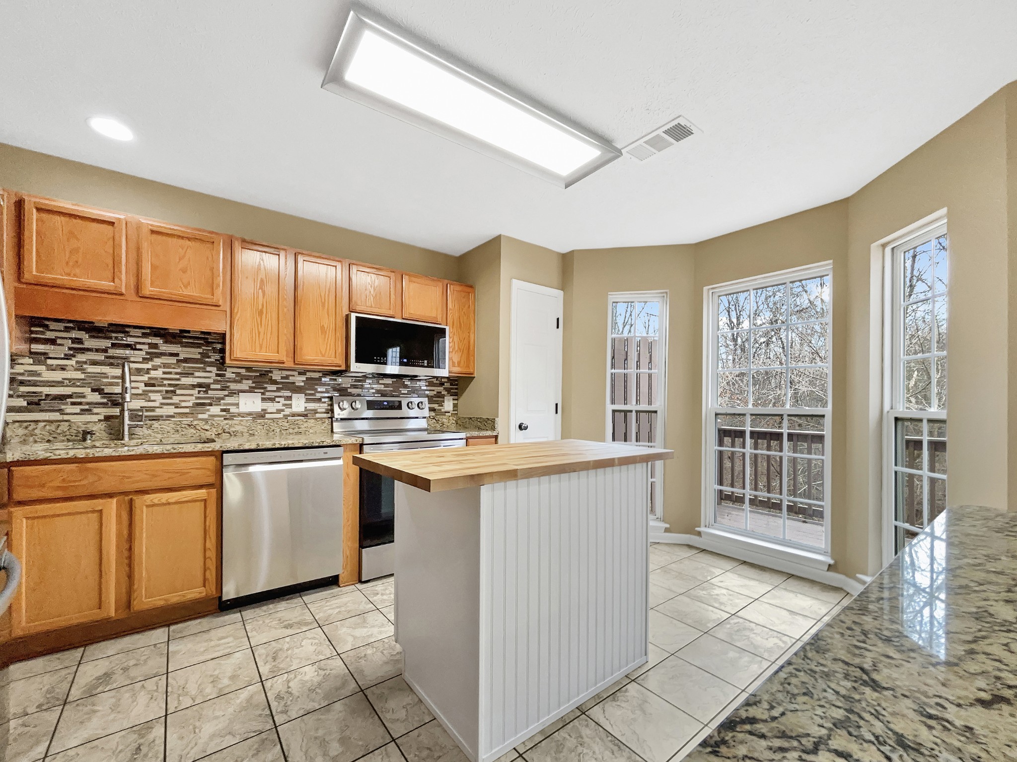 741 Tulip Grove Road, Unit 603 Hermitage, TN 37076 - Photo 2 of 17 a kitchen with stainless steel appliances granite countertop a stove top oven a sink dishwasher and a refrigerator
