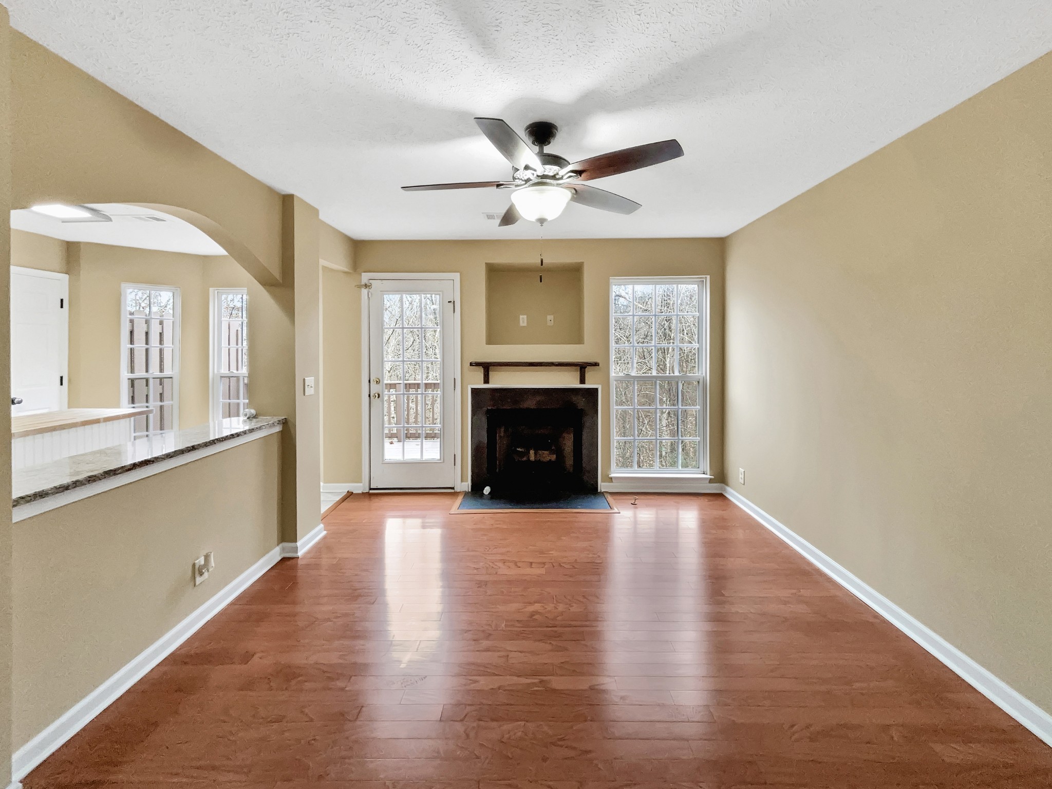 741 Tulip Grove Road, Unit 603 Hermitage, TN 37076 - Photo 3 of 17 a view of a livingroom with wooden floor a ceiling fan and windows