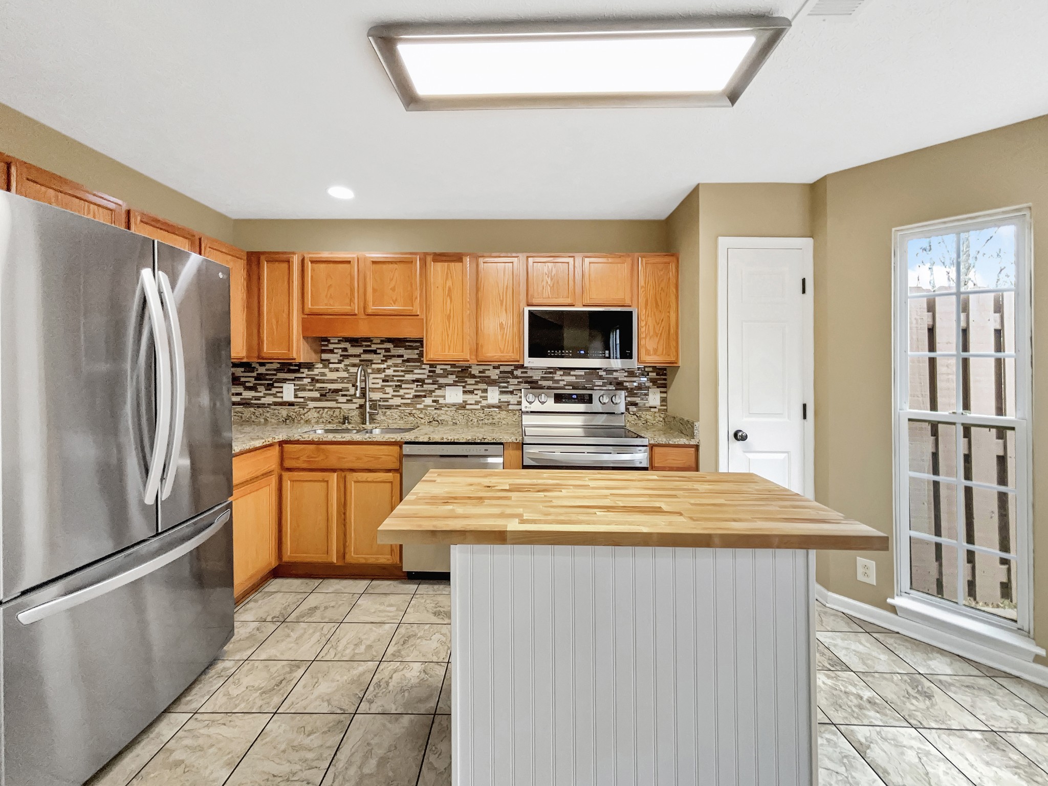 741 Tulip Grove Road, Unit 603 Hermitage, TN 37076 - Photo 9 of 17 a kitchen with stainless steel appliances a refrigerator sink and microwave