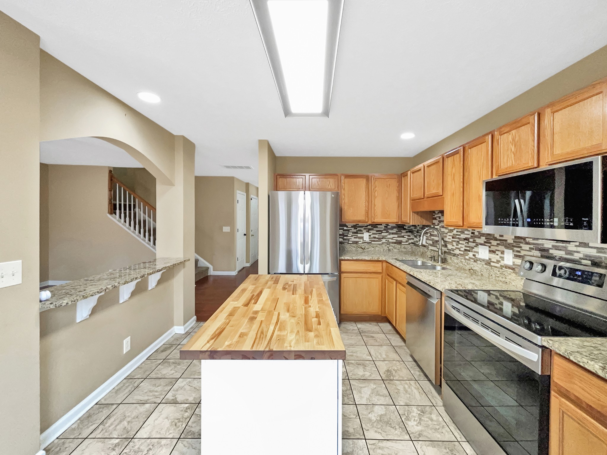 741 Tulip Grove Road, Unit 603 Hermitage, TN 37076 - Photo 10 of 17 a kitchen with stainless steel appliances granite countertop a stove and a sink
