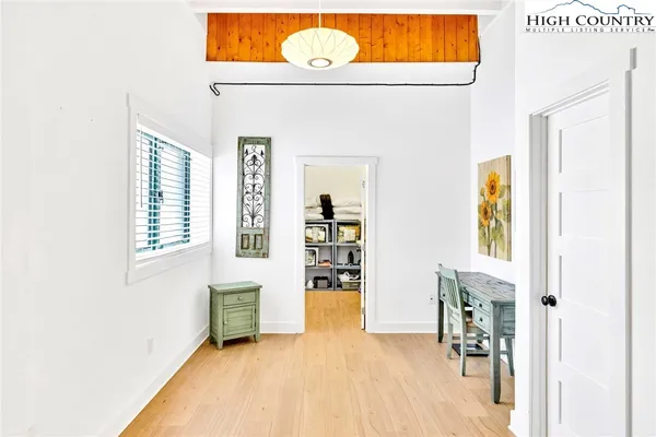 a view of an entryway with wooden floor
