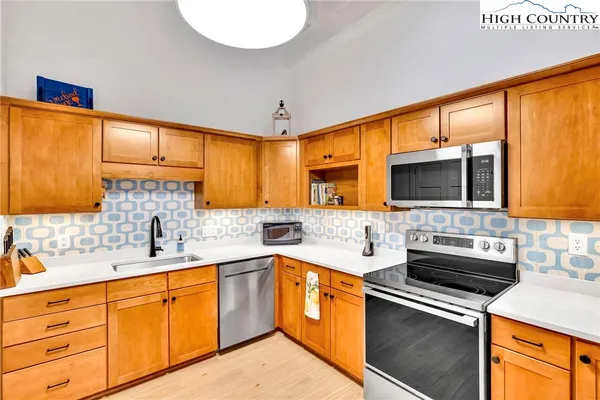 a kitchen with a sink stove and microwave