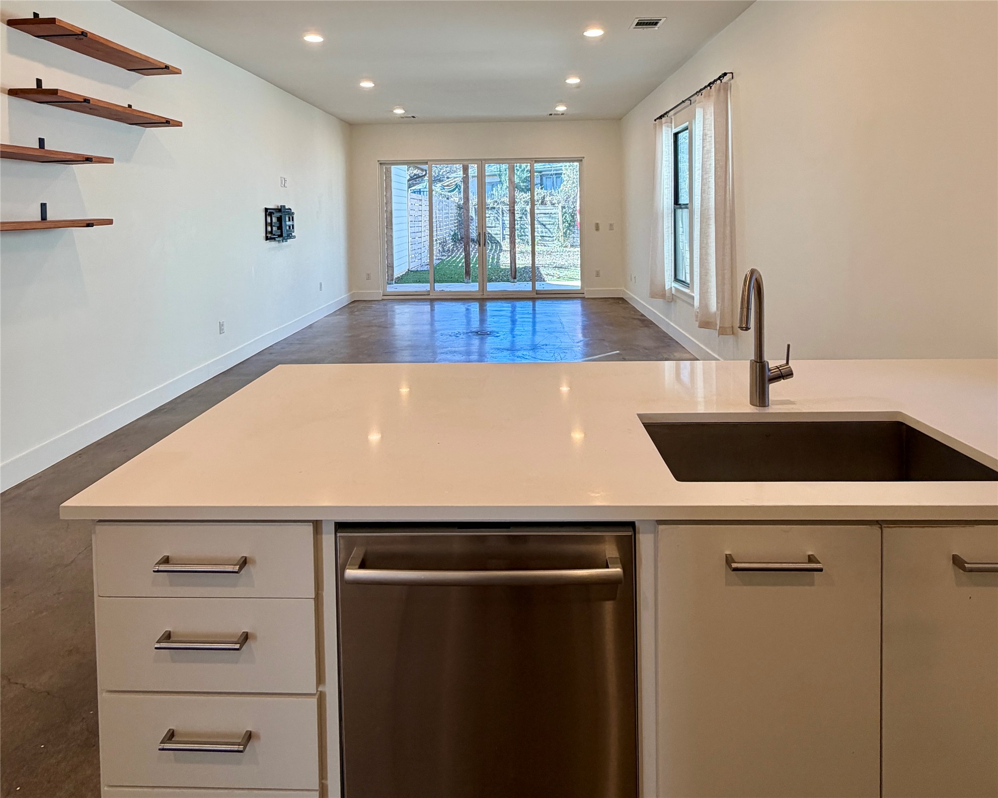 1515 Hether Street, Unit B Austin, TX 78704 - Photo 5 of 30 A contemporary open-concept layout features sleek countertops and seamless outdoor access.