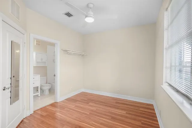 a bathroom with a bathtub shower sink vanity and toilet
