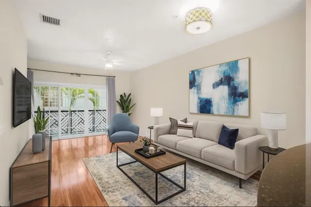a living room with furniture a table and a flat screen tv