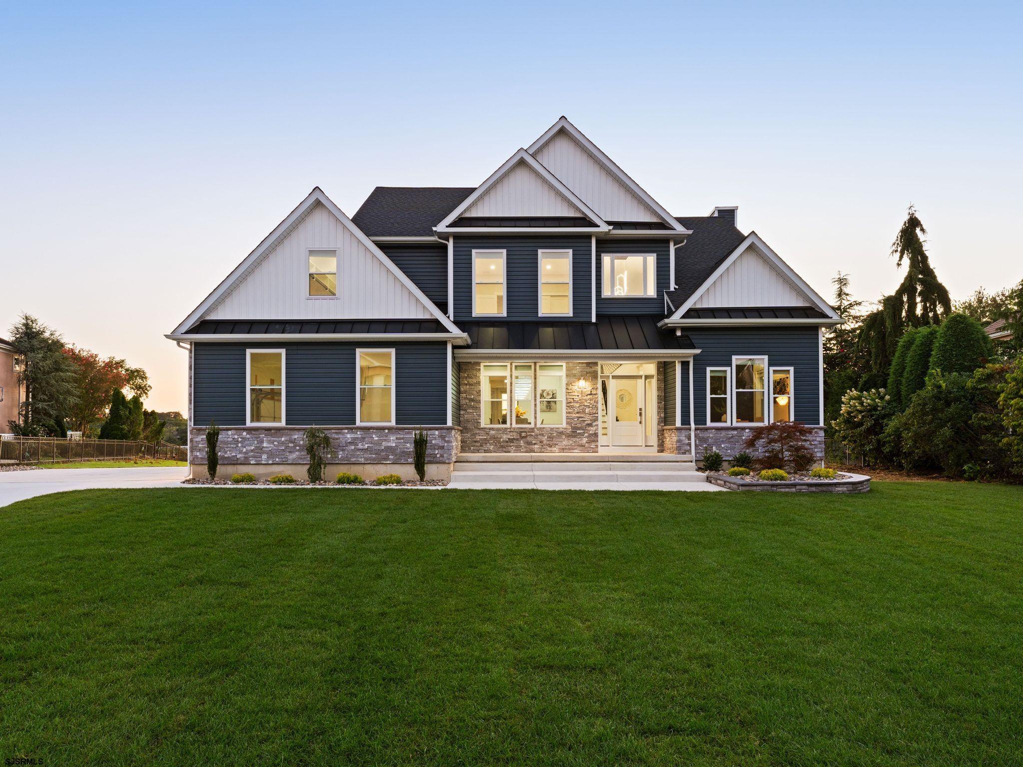a front view of a house with a garden