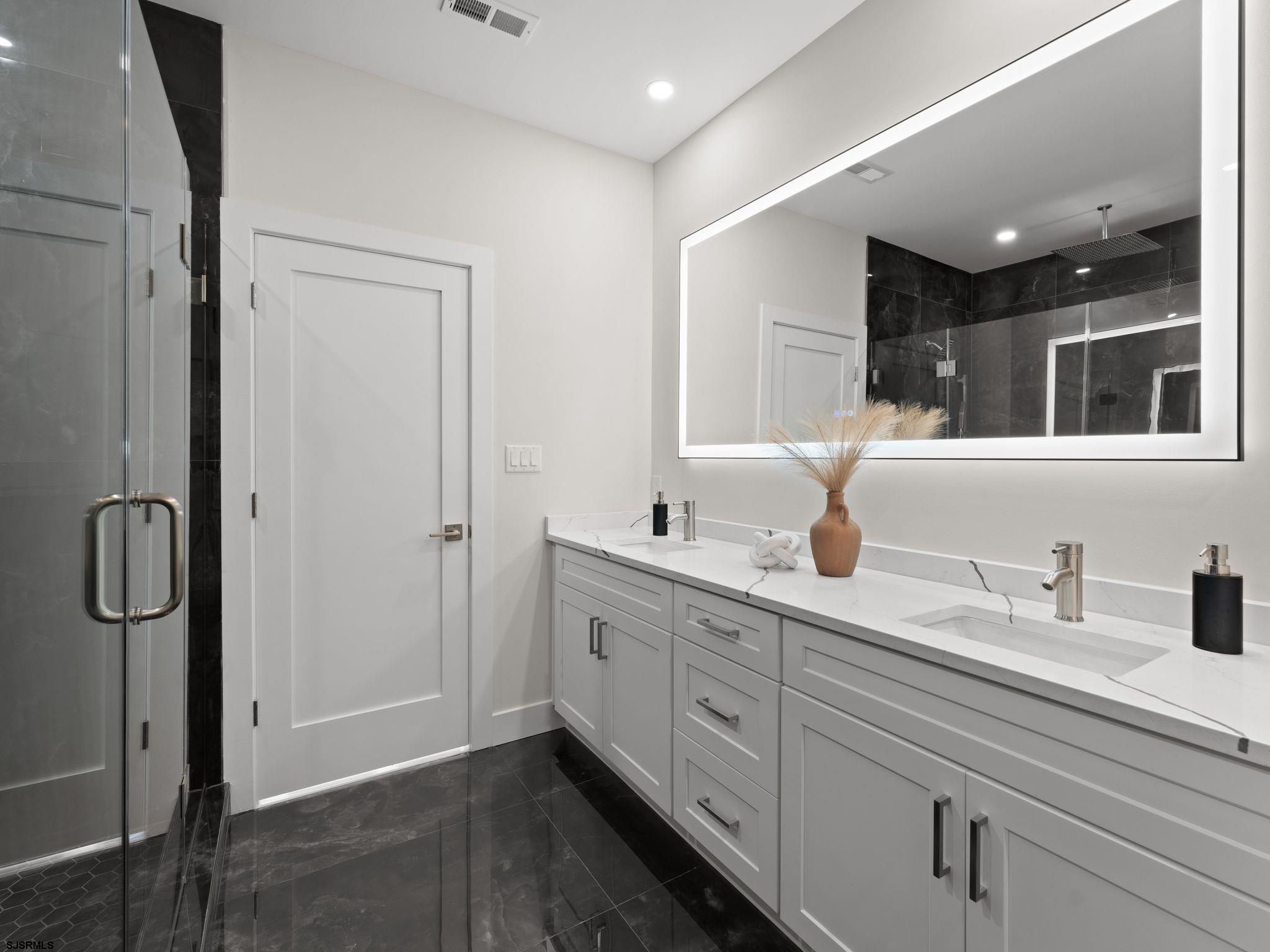 14 Wexford Lane Linwood, NJ 08221 - Photo 33 of 76 a bathroom with a double vanity sink double mirror and shower