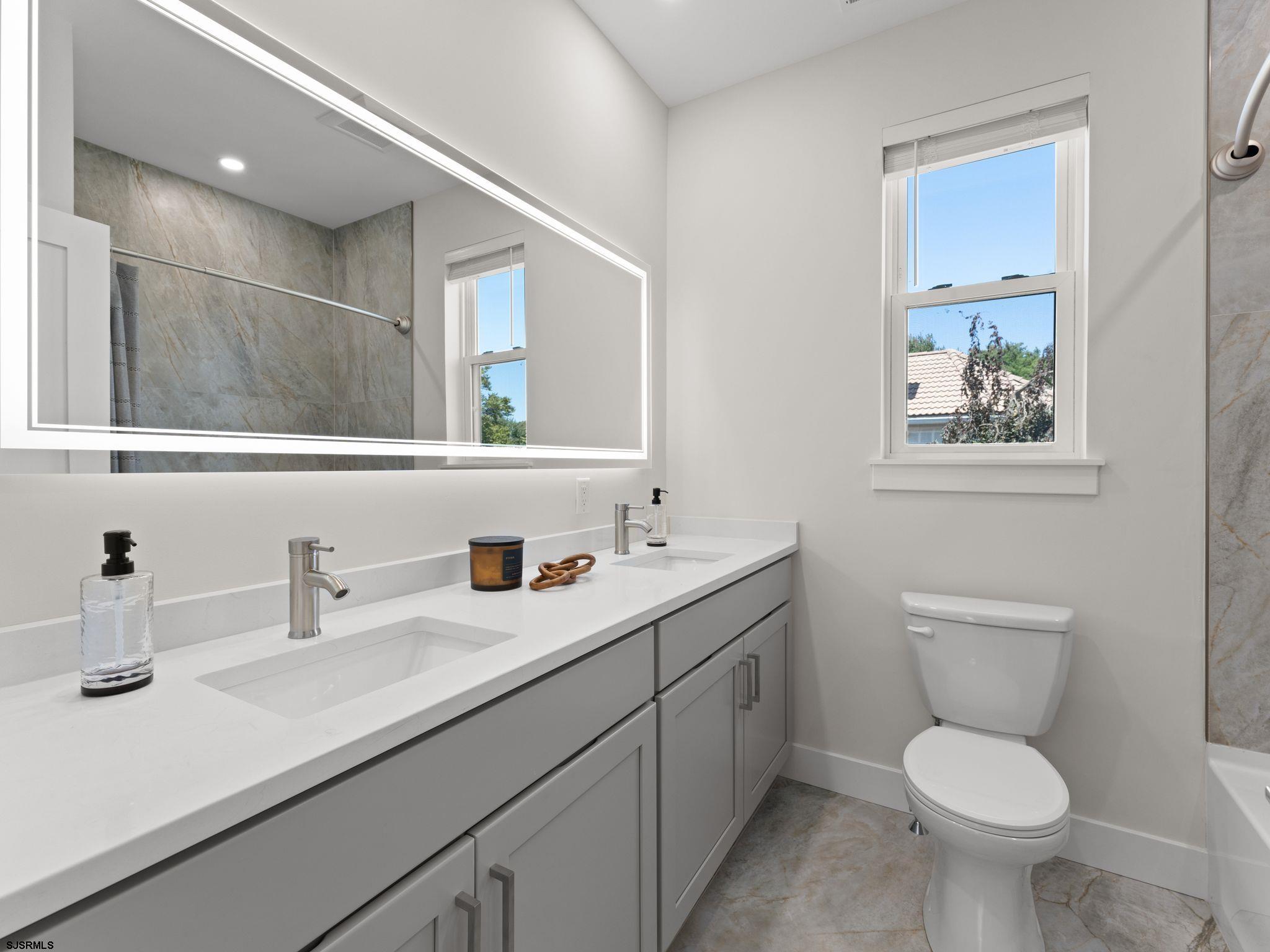14 Wexford Lane Linwood, NJ 08221 - Photo 43 of 76 a bathroom with a toilet sink and mirror