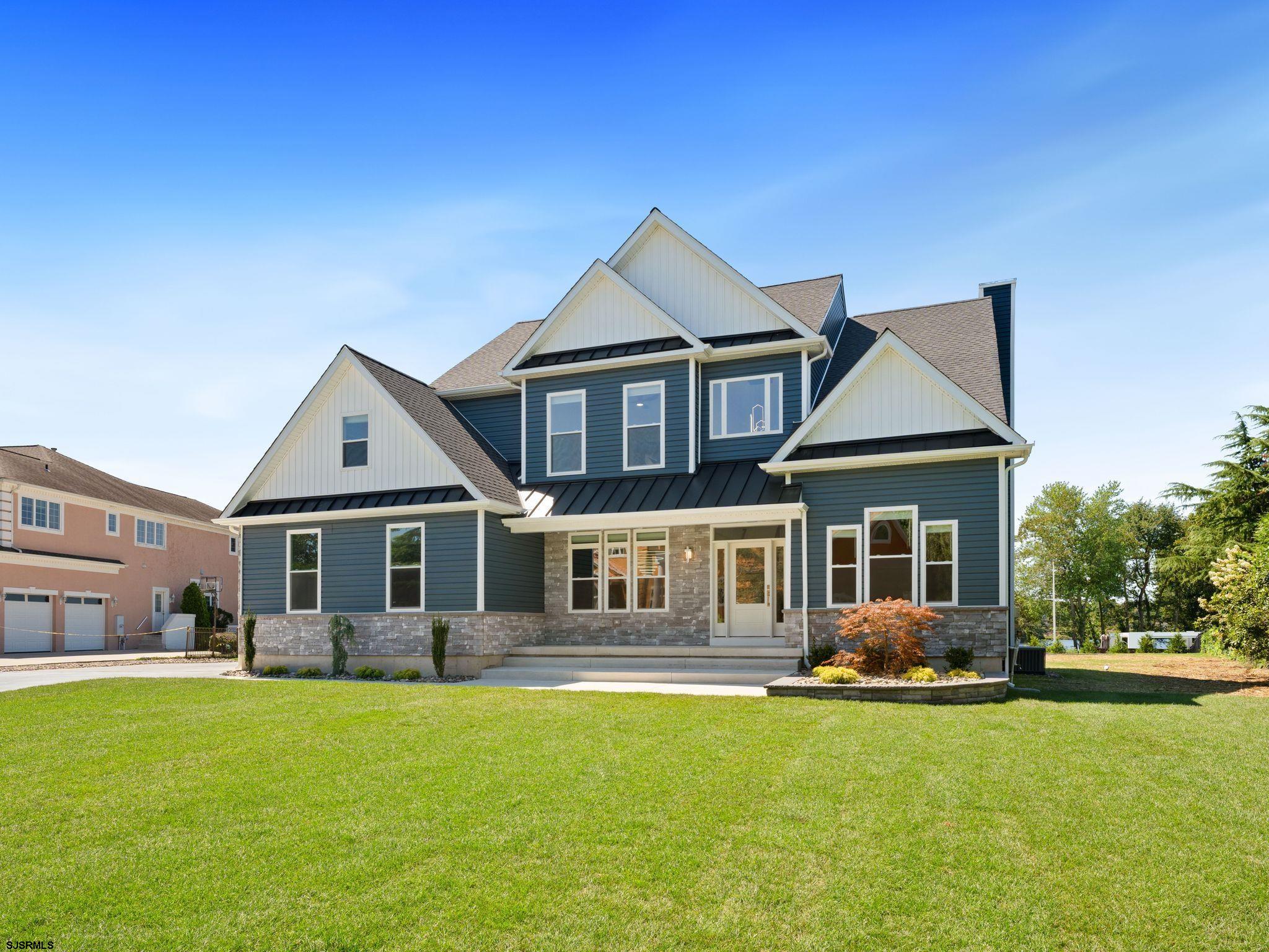 14 Wexford Lane Linwood, NJ 08221 - Photo 5 of 76 a front view of a house with a garden and porch