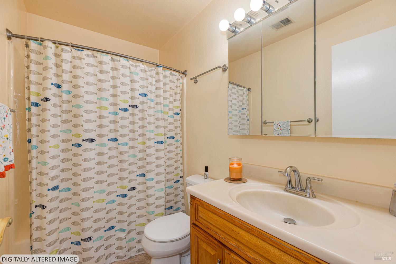 1387 Gillpepper Lane Rohnert Park, CA 94928 - Photo 15 of 36 a bathroom with a sink a toilet and shower curtain