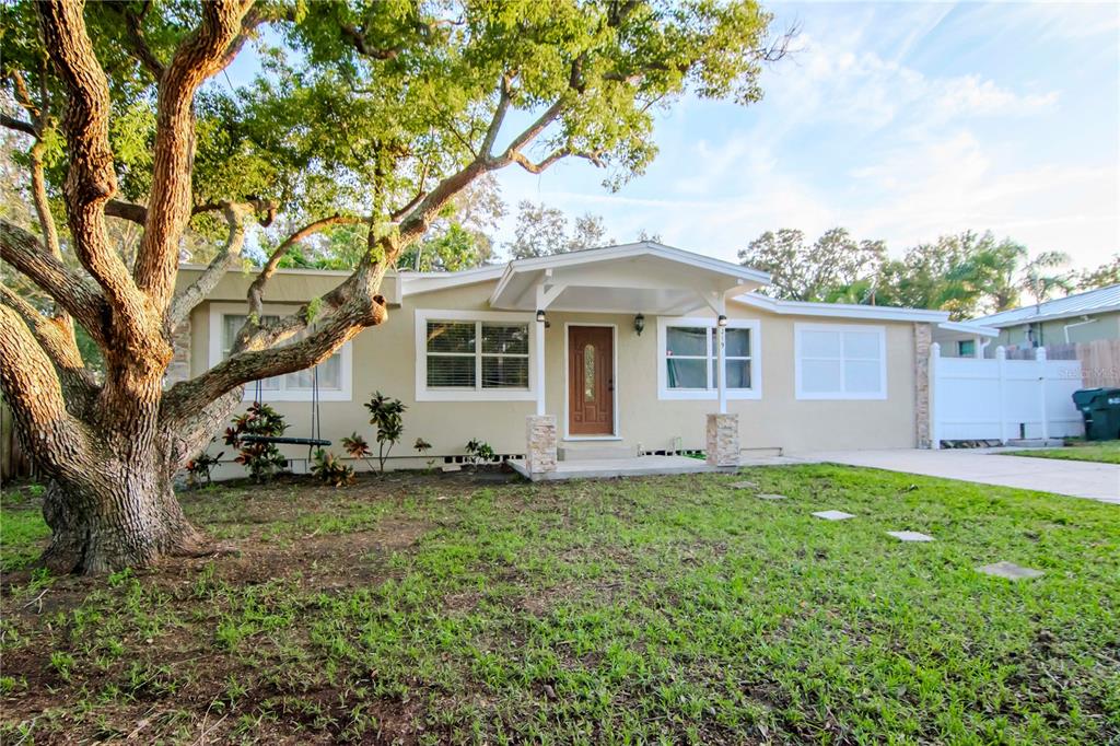 219 6th Avenue Southwest Largo, FL 33770 - Photo 1 of 1 a front view of a house with a garden