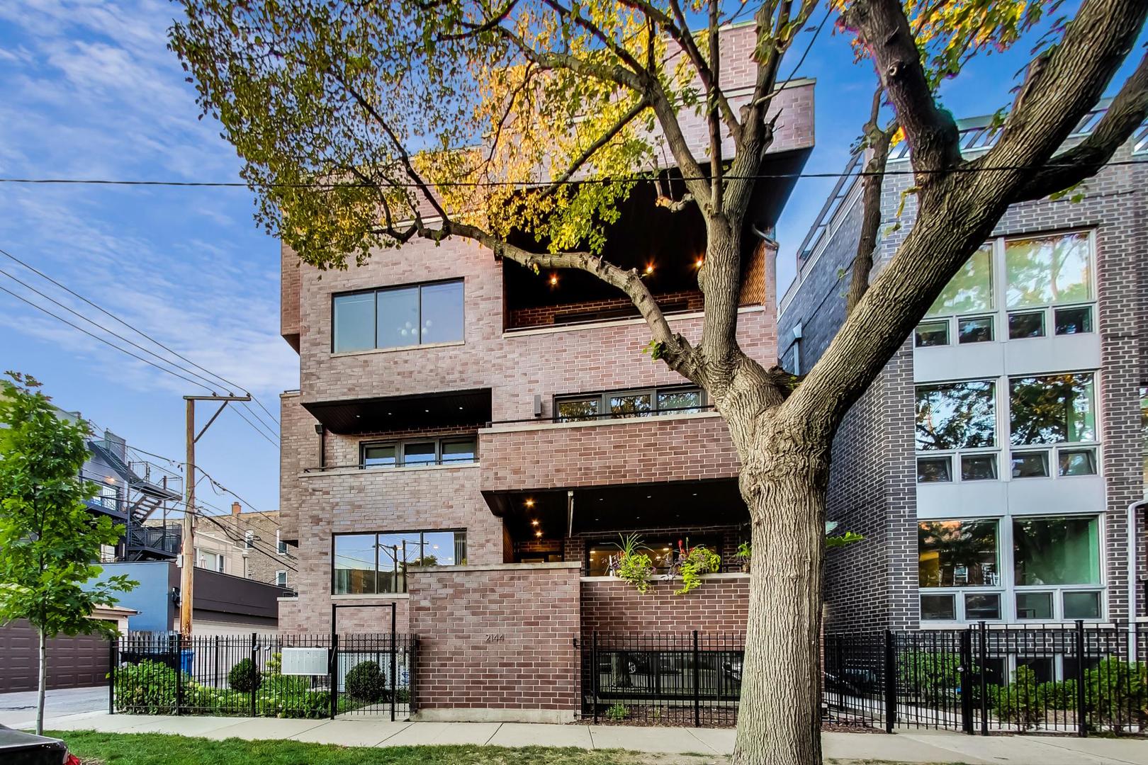 2144 West Rice Street, Unit 3E Chicago, IL 60622 - Photo 1 of 19 a tree in front of a building