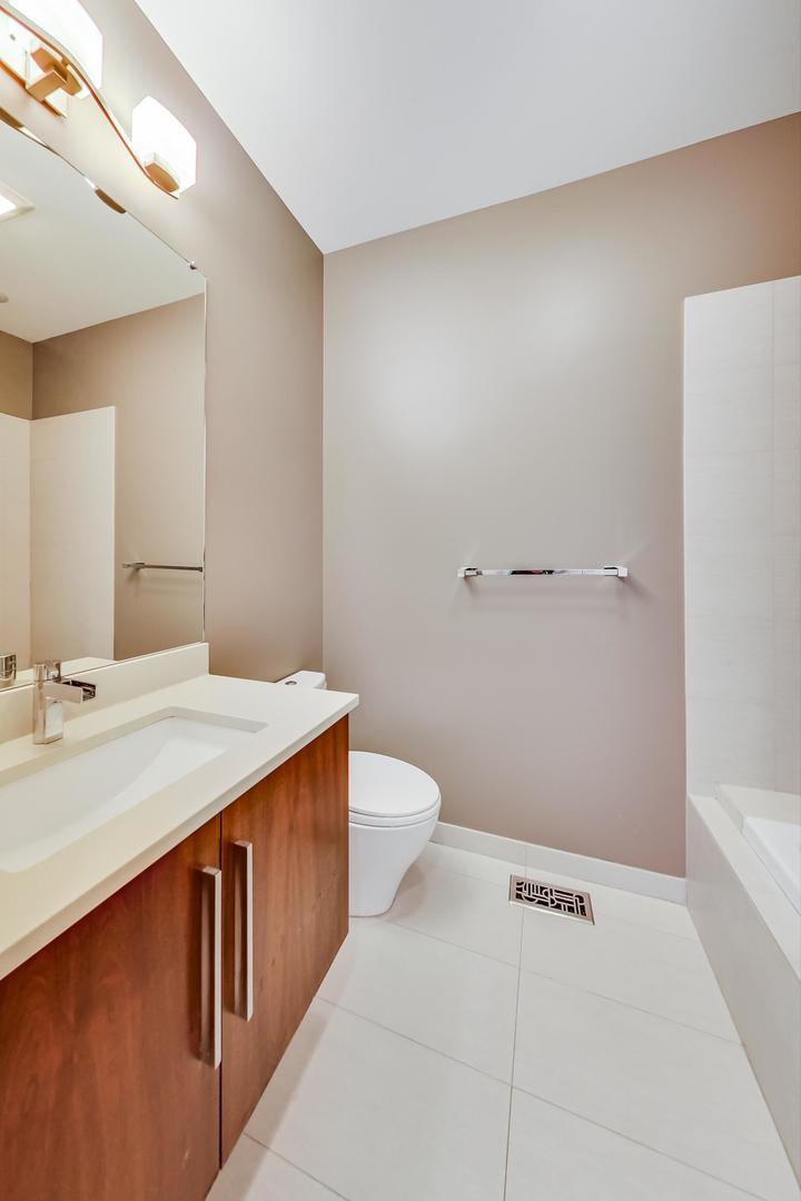 2144 West Rice Street, Unit 3E Chicago, IL 60622 - Photo 13 of 19 a bathroom with a sink a toilet and mirror