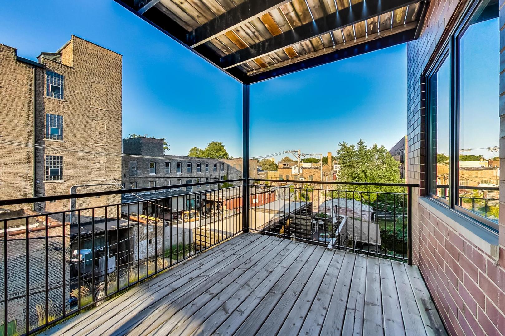 2144 West Rice Street, Unit 3E Chicago, IL 60622 - Photo 5 of 19 a view of balcony with couch and wooden floor
