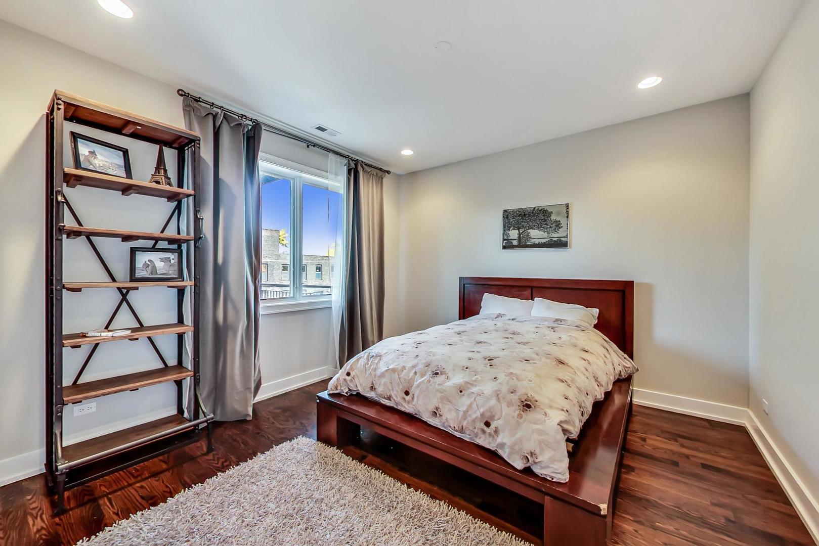 2144 West Rice Street, Unit 3E Chicago, IL 60622 - Photo 6 of 19 a bedroom with bed and wooden floor