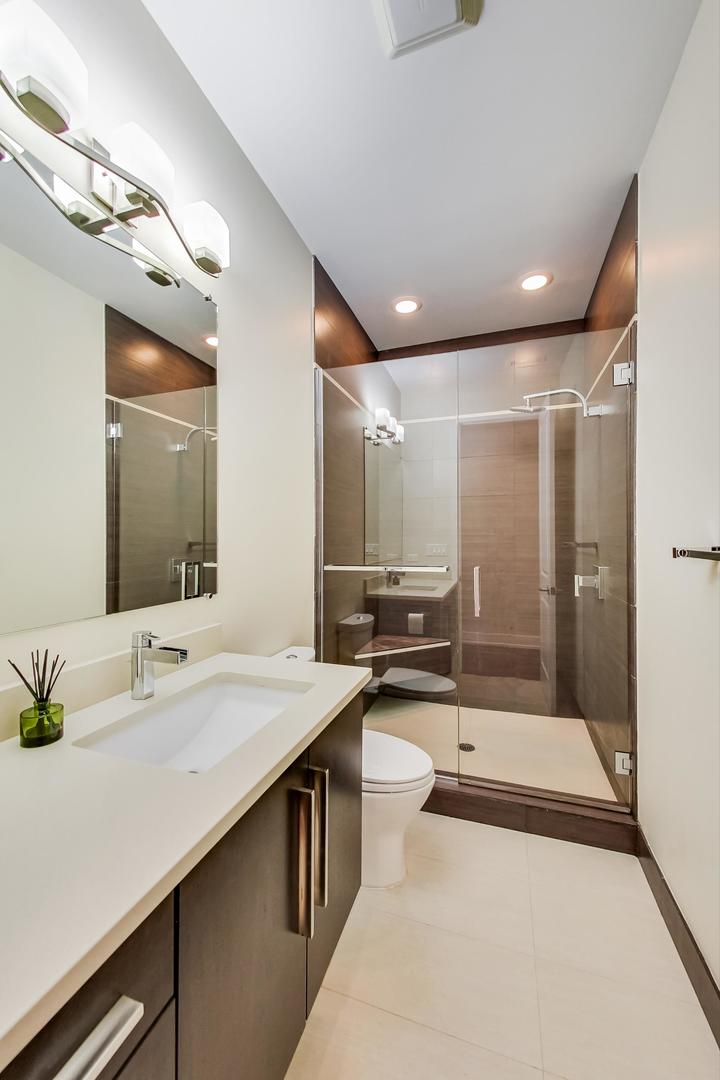 2144 West Rice Street, Unit 3E Chicago, IL 60622 - Photo 7 of 19 a bathroom with a sink and a mirror