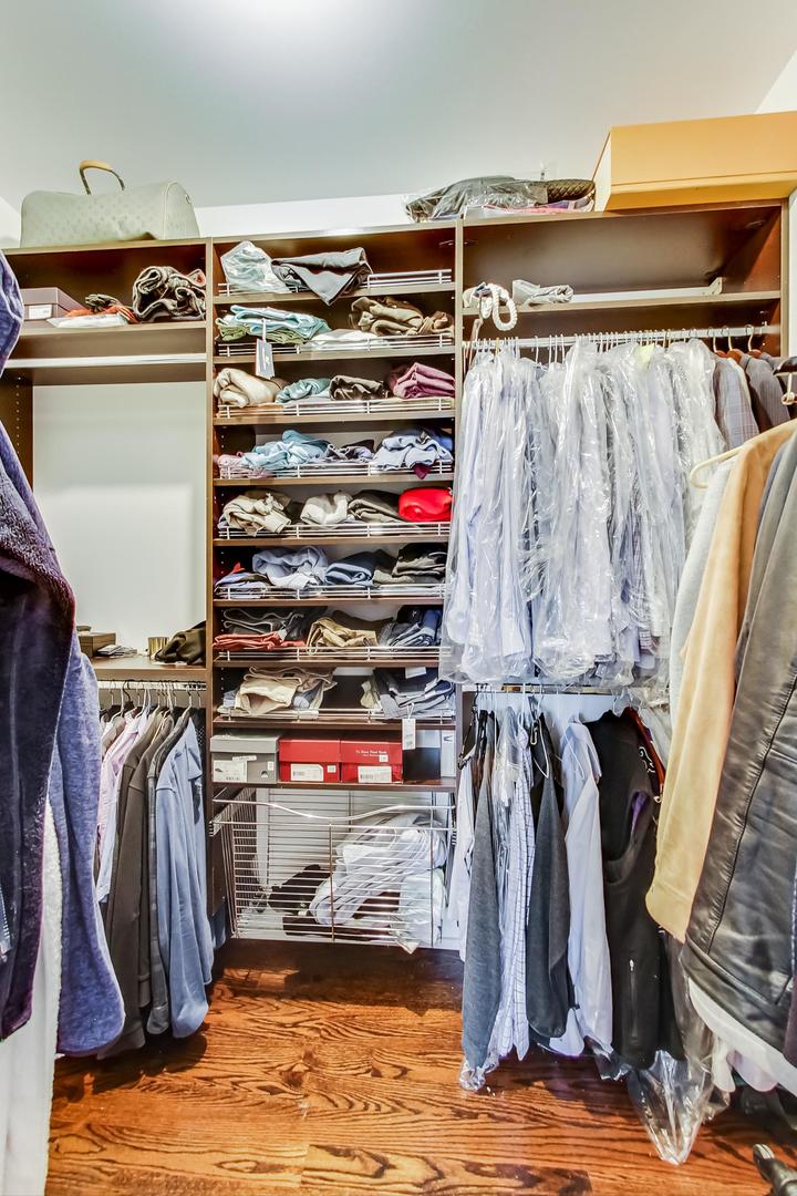 2144 West Rice Street, Unit 3E Chicago, IL 60622 - Photo 8 of 19 a view of walk in closet with clothes and shoes