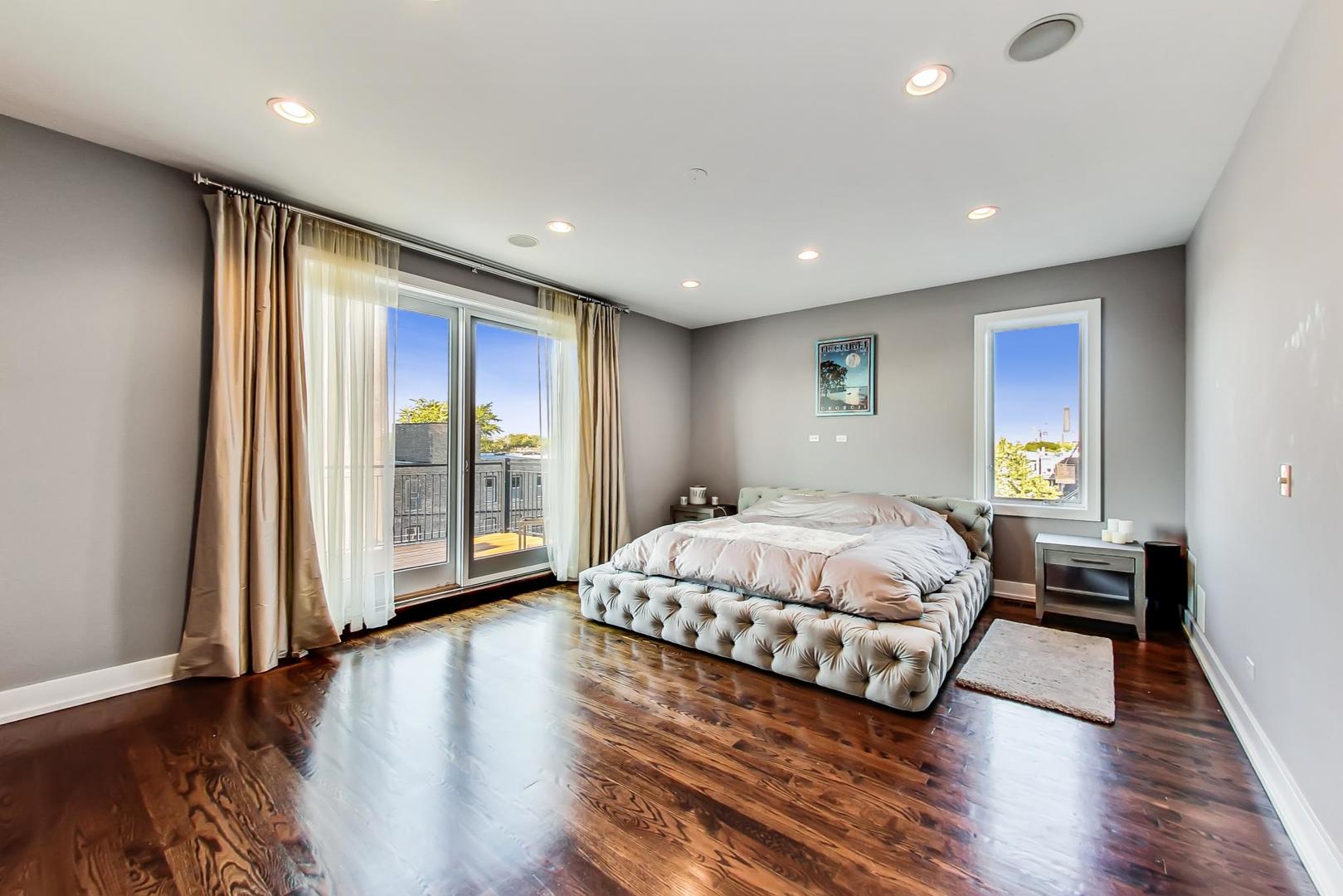 2144 West Rice Street, Unit 3E Chicago, IL 60622 - Photo 9 of 19 a spacious bedroom with a large bed and a large window