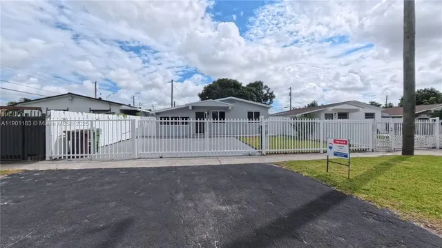 a view of a house with a yard and sitting area