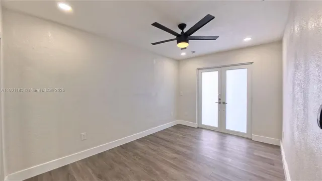 a view of a room with wooden floor and window
